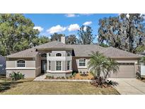 Charming home featuring a well-manicured lawn, circular turret entrance, and neutral color palette at 15803 Fairview Pt, Tavares, FL 32778