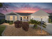 Charming single-story home featuring a well-maintained lawn and inviting curb appeal with a lovely sky at 1417 Forest Acres Dr, The Villages, FL 32162
