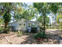 Charming single-story home with a lush, tree-filled yard and well-maintained landscaping at 17108 Pine Ridge Dr, Umatilla, FL 32784
