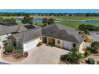 Lovely single-story home with an attached two car garage overlooking a lush golf course and pond at 1907 Anderson Ct, The Villages, FL 32162