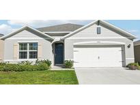 Charming single-story home features a well-manicured lawn and a two-car garage at 2916 Canary Ln, Tavares, FL 32778