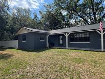 Charming single story home with a covered front porch and manicured lawn at 1107 Valley Rd, Fruitland Park, FL 34731