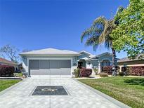 Charming single-story home with a well-maintained lawn and a two-car garage at 1738 Sw 157Th Place Rd, Ocala, FL 34473