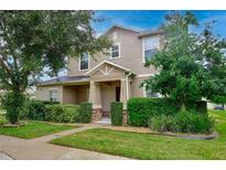 Charming two-story home featuring a manicured lawn and lovely landscaping with a covered front porch at 1852 Rafton Rd, Apopka, FL 32703