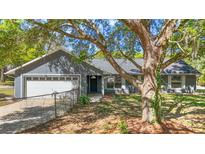 Charming single-story home with a well-maintained lawn and a tree in the front yard at 331 W Lewis Ave, Apopka, FL 32712