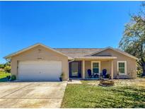 Charming single-story home featuring an attached two-car garage and a well-manicured front lawn at 6679 Cr 613, Bushnell, FL 33513