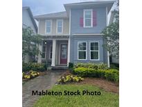 Charming two-story home featuring two-tone siding, colorful landscaping, and a welcoming front entrance at 9905 Gobat Aly, Orlando, FL 32827