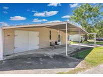 The exterior features a carport and shed, providing covered parking and additional storage space at 1405 Westland Dr, Tavares, FL 32778