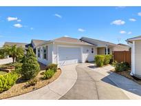 Charming single-story home with a well-manicured lawn and a two-car garage, blending comfort and convenience at 5829 Tupelo Ter, The Villages, FL 32163