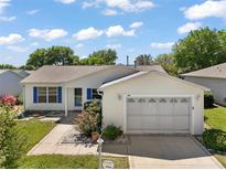 Charming single-story home with a well-maintained lawn, inviting entrance, and two car garage at 7650 Se 174Th Gaillard Pl, The Villages, FL 32162