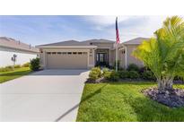 Charming single-story home featuring a well-maintained lawn, beige exterior, and attached two car garage at 3641 Arlington Ridge Blvd, Leesburg, FL 34748