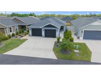 Charming home features a well-maintained front yard, a two-car garage, and excellent curb appeal at 5549 Millican Ave, The Villages, FL 32163