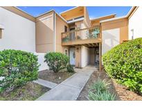 Charming condo featuring a private balcony, well-kept landscaping, and welcoming entryway at 1051 S Highland St # 4B, Mount Dora, FL 32757