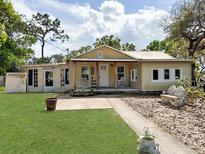 Charming single-story home with a welcoming front porch and landscaped front yard at 1425 Douglas Rd, Groveland, FL 34736