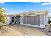 Charming single-story home with a two-car garage and well-maintained landscaping at 1917 Peachtree Ave, The Villages, FL 32162