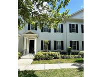 Charming two-story townhouse with black shutters and well-manicured landscaping at 2261 Osprey Ave, Orlando, FL 32814