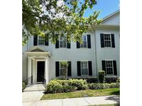 Charming two-story townhome with black shutters, manicured landscaping, and inviting front entrance at 2261 Osprey Ave, Orlando, FL 32814