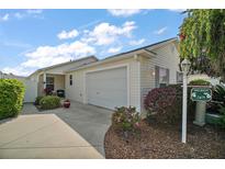 Charming single-story home with a well-manicured front yard, attached garage, and inviting curb appeal at 2471 Yalaha Ave, The Villages, FL 32162
