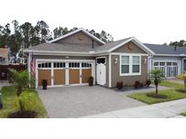Charming home featuring a brick-paved driveway, a two-car garage and tidy landscaping at 368 Alcove Dr, Groveland, FL 34736