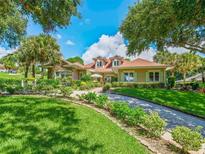 Charming single-Gathering home with manicured lawn, stone accents and beautiful landscaping at 39023 Griffin Lndg, Lady Lake, FL 32159