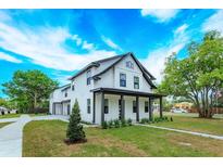 Beautiful two-story white home with black trim, manicured lawn, and inviting front porch at 1336 Crystal Lake E Ave, Orlando, FL 32806