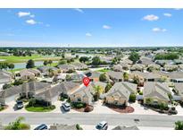 An aerial view of a beautiful single-Gathering home in a lush community with water views, mature landscaping, and serene surroundings at 1536 Barnwell Pl, The Villages, FL 32162