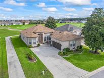 Stunning single-story home boasts lush landscaping and a golf course view at 17769 Se 121St Terrace Rd, Summerfield, FL 34491