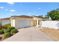Charming single-story home with a well-maintained lawn, inviting front entrance, and two car garage at 2042 Hydrangea Ave, The Villages, FL 32162