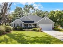 Charming one-story home featuring a well-manicured lawn and an attached two-car garage at 301 Brookstone Ln, Fruitland Park, FL 34731
