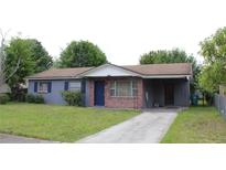 Charming single-story home features a brick and gray painted exterior, an open carport, and a well-maintained front lawn at 5177 Edwina St, Orlando, FL 32811