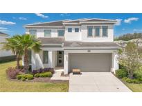 Beautiful two-story home featuring a neutral color palette and well-manicured front yard at 598 Marcello Blvd, Kissimmee, FL 34746