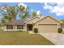 Charming single-story home with a well-maintained lawn, neutral paint and inviting curb appeal at 814 Olive Ave, Fruitland Park, FL 34731