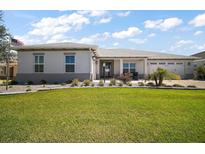Charming single-story home with well-manicured lawn and mature landscaping under a sunny sky at 8433 Sw 98Th Terrace Rd, Ocala, FL 34481