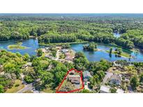 Stunning aerial view of home with lush greenery and beautiful lake views in a desirable neighborhood at 12110 Palmetto Ct, Dunnellon, FL 34432