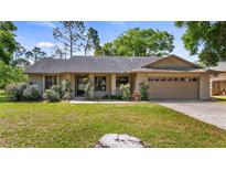 Charming single-story home featuring a well-maintained lawn and attached two car garage at 15918 Summit Ct, Clermont, FL 34711