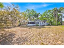 Charming single-story house with a large yard and mature trees, full of character at 16724 Highland Ave, Montverde, FL 34756