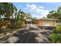 Charming single-story home with a lush front yard and a two-car garage at 2121 Suzanne Dr, Mount Dora, FL 32757