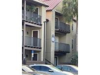 Condominium exterior featuring balconies, neutral paint, and well-maintained landscaping for a welcoming appeal at 236 Afton Sq # 309, Altamonte Springs, FL 32714