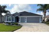 Charming one-story home with well-maintained landscaping and a three-car garage at 3942 Zenith Loop, The Villages, FL 32163