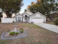 Charming single-Gathering home with a manicured front yard and a two-car garage at 10339 Patrick Dr, Leesburg, FL 34788