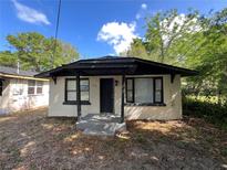 Charming, single-story home featuring a covered front porch and neutral-colored brick at 2107 Hollywood Ave, Eustis, FL 32726