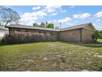Well-kept single story home with a brick exterior and lush green front lawn with established shrubbery at 30641 County Road 435, Sorrento, FL 32776