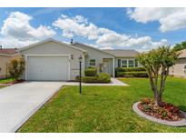 Charming single-story home with well-maintained landscaping and an attached garage at 870 Danforth Ct, The Villages, FL 32162