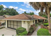 Charming single-story home featuring a well-manicured lawn, attached garage and welcoming curb appeal at 1512 S Pointe Dr, Leesburg, FL 34748