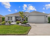 Charming single-story home with a well-manicured lawn and a two car garage at 2170 Biller Cir, The Villages, FL 32163