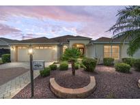 Charming single-Gathering home with manicured landscaping, brick driveway, and a two-car garage at 278 Matisse Ave, The Villages, FL 32162