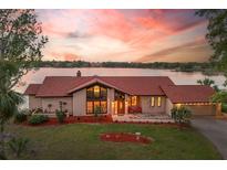 Scenic aerial view of a lakefront property, with beautiful landscaping, waterfront access, and charming curb appeal at 3011 Lake Woodward Dr, Eustis, FL 32726