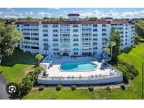 Spacious condo complex with a refreshing community pool and a well-maintained landscaped lawn at 601 N Mcdonald St # 408, Mount Dora, FL 32757