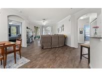 Open living area with wood floors, ceiling fan, neutral color, and access to a bedroom and outdoor seating at 8256 Maritime Flag St # 103, Windermere, FL 34786