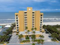 Beautiful beachfront condo building featuring ocean views and tropical landscaping at 1705 S Atlantic Ave # 502, New Smyrna Beach, FL 32169